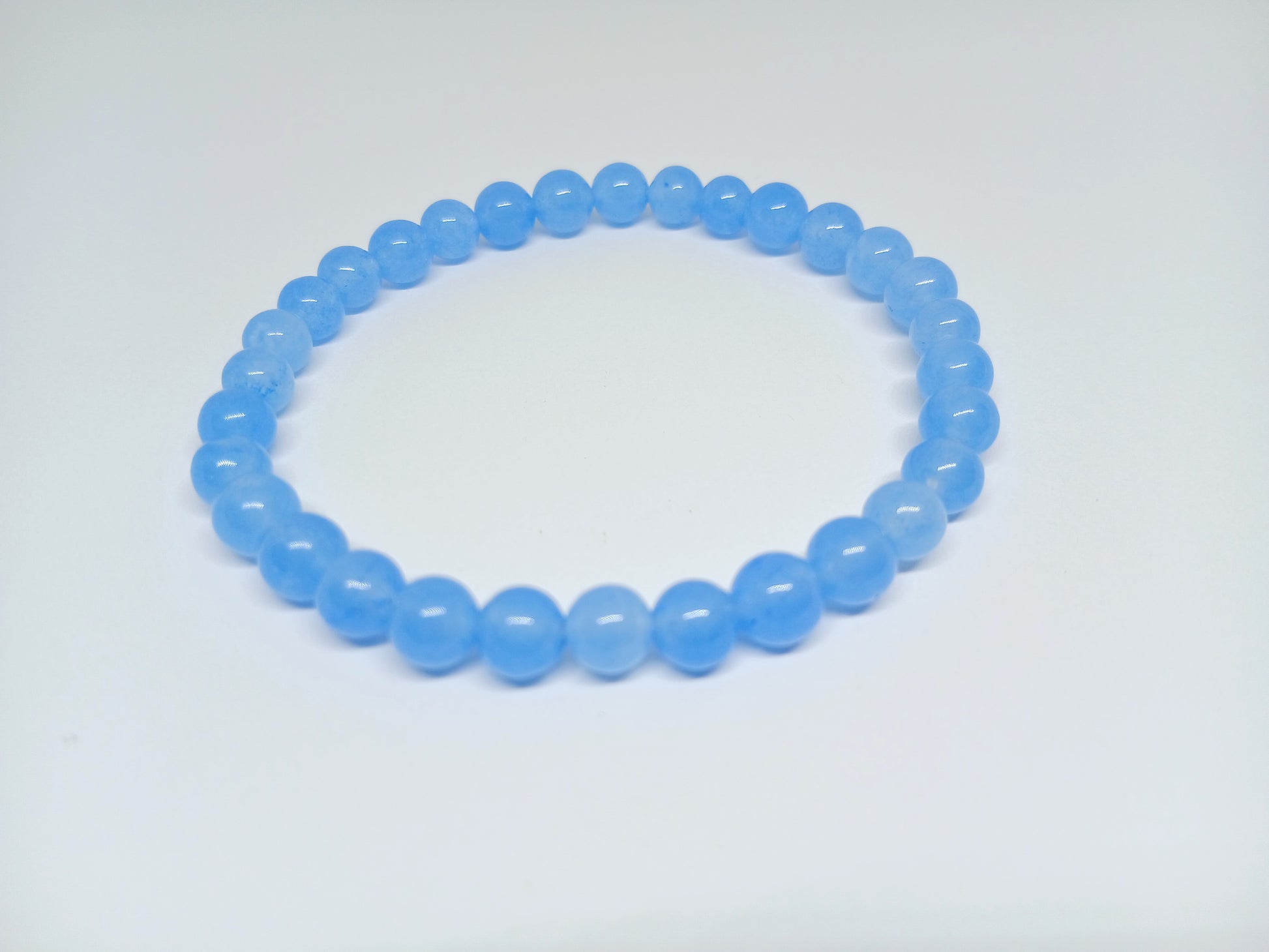 Chalcedony Bracelet featuring healing blue beads crafted from natural crystal stones, designed as a stretch friendship bracelet for women and men. This handmade round beaded jewelry piece promotes calmness, emotional balance, and positive energy. Lightweight and comfortable, it makes a meaningful gift symbolizing connection and wellness. Perfect for everyday wear or spiritual practices, combining artisanal craftsmanship with the soothing beauty of chalcedony gemstones.