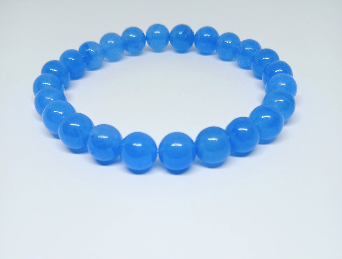 Chalcedony Bracelet featuring healing blue beads crafted from natural crystal stones, designed as a stretch friendship bracelet for women and men. This handmade round beaded jewelry piece promotes calmness, emotional balance, and positive energy. Lightweight and comfortable, it makes a meaningful gift symbolizing connection and wellness. Perfect for everyday wear or spiritual practices, combining artisanal craftsmanship with the soothing beauty of chalcedony gemstones.