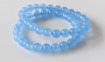 Chalcedony Bracelet featuring healing blue beads crafted from natural crystal stones, designed as a stretch friendship bracelet for women and men. This handmade round beaded jewelry piece promotes calmness, emotional balance, and positive energy. Lightweight and comfortable, it makes a meaningful gift symbolizing connection and wellness. Perfect for everyday wear or spiritual practices, combining artisanal craftsmanship with the soothing beauty of chalcedony gemstones.