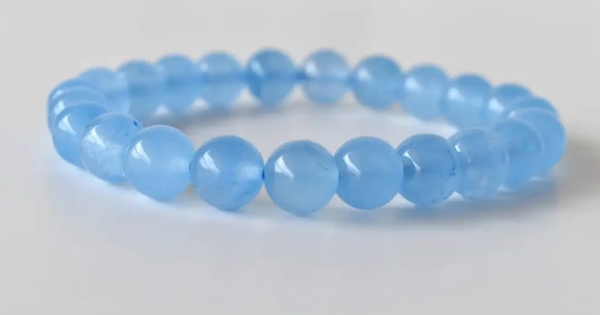 Chalcedony Bracelet featuring healing blue beads crafted from natural crystal stones, designed as a stretch friendship bracelet for women and men. This handmade round beaded jewelry piece promotes calmness, emotional balance, and positive energy. Lightweight and comfortable, it makes a meaningful gift symbolizing connection and wellness. Perfect for everyday wear or spiritual practices, combining artisanal craftsmanship with the soothing beauty of chalcedony gemstones.