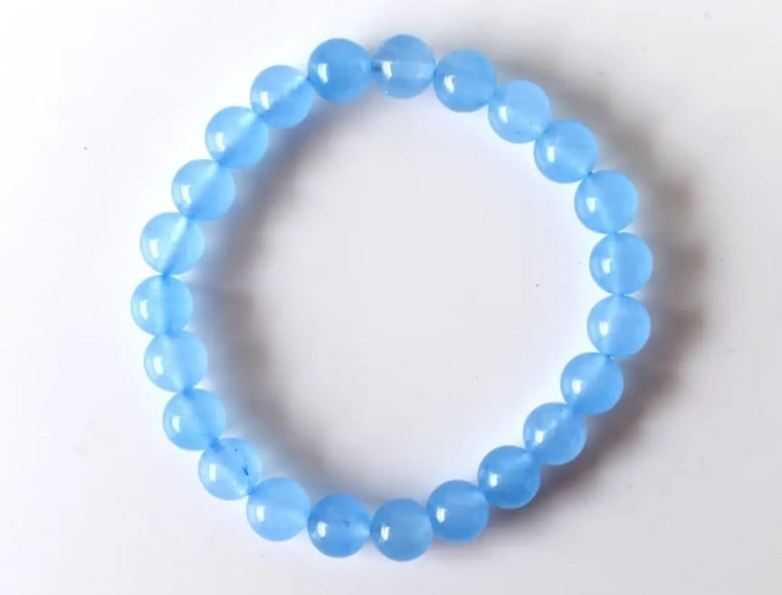 Chalcedony Bracelet featuring healing blue beads crafted from natural crystal stones, designed as a stretch friendship bracelet for women and men. This handmade round beaded jewelry piece promotes calmness, emotional balance, and positive energy. Lightweight and comfortable, it makes a meaningful gift symbolizing connection and wellness. Perfect for everyday wear or spiritual practices, combining artisanal craftsmanship with the soothing beauty of chalcedony gemstones.