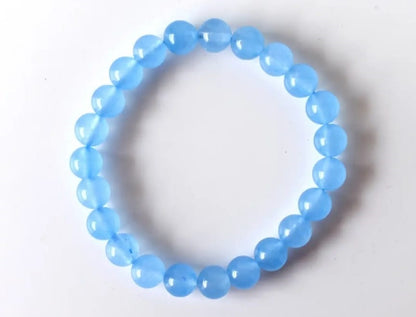 Chalcedony Bracelet featuring healing blue beads crafted from natural crystal stones, designed as a stretch friendship bracelet for women and men. This handmade round beaded jewelry piece promotes calmness, emotional balance, and positive energy. Lightweight and comfortable, it makes a meaningful gift symbolizing connection and wellness. Perfect for everyday wear or spiritual practices, combining artisanal craftsmanship with the soothing beauty of chalcedony gemstones.
