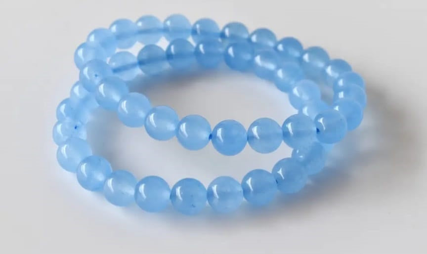 Chalcedony Bracelet featuring healing blue beads crafted from natural crystal stones, designed as a stretch friendship bracelet for women and men. This handmade round beaded jewelry piece promotes calmness, emotional balance, and positive energy. Lightweight and comfortable, it makes a meaningful gift symbolizing connection and wellness. Perfect for everyday wear or spiritual practices, combining artisanal craftsmanship with the soothing beauty of chalcedony gemstones.