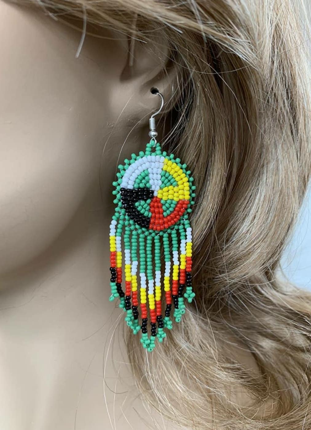 Native Style Colorful Beaded Earrings featuring a large sunburst dangle design with vibrant beads in bold boho ethnic patterns. These handmade festival fashion earrings add lively color and intricate artistry to any outfit. Perfect gift for women who appreciate unique, handcrafted jewelry with cultural significance. Lightweight and striking, ideal for festivals, casual wear, or special occasions. Celebrate artisan craftsmanship and bohemian style.