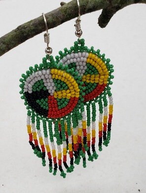 Native Style Colorful Beaded Earrings featuring a large sunburst dangle design with vibrant beads in bold boho ethnic patterns. These handmade festival fashion earrings add lively color and intricate artistry to any outfit. Perfect gift for women who appreciate unique, handcrafted jewelry with cultural significance. Lightweight and striking, ideal for festivals, casual wear, or special occasions. Celebrate artisan craftsmanship and bohemian style.