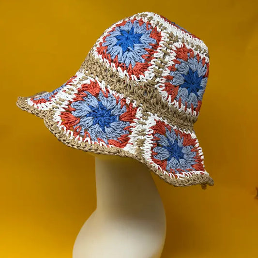 Cottage Summer Sun Hat featuring a blue, red, and white crochet bucket design, perfect for women who love stylish and functional beachwear. This wide brim fisherman hat offers excellent sun protection with a breathable straw construction, combining comfort and fashion. Ideal for summer outings, beach trips, or casual wear, this handmade hat blends classic cottagecore charm with practical sun safety, making it a versatile accessory for sunny days.
