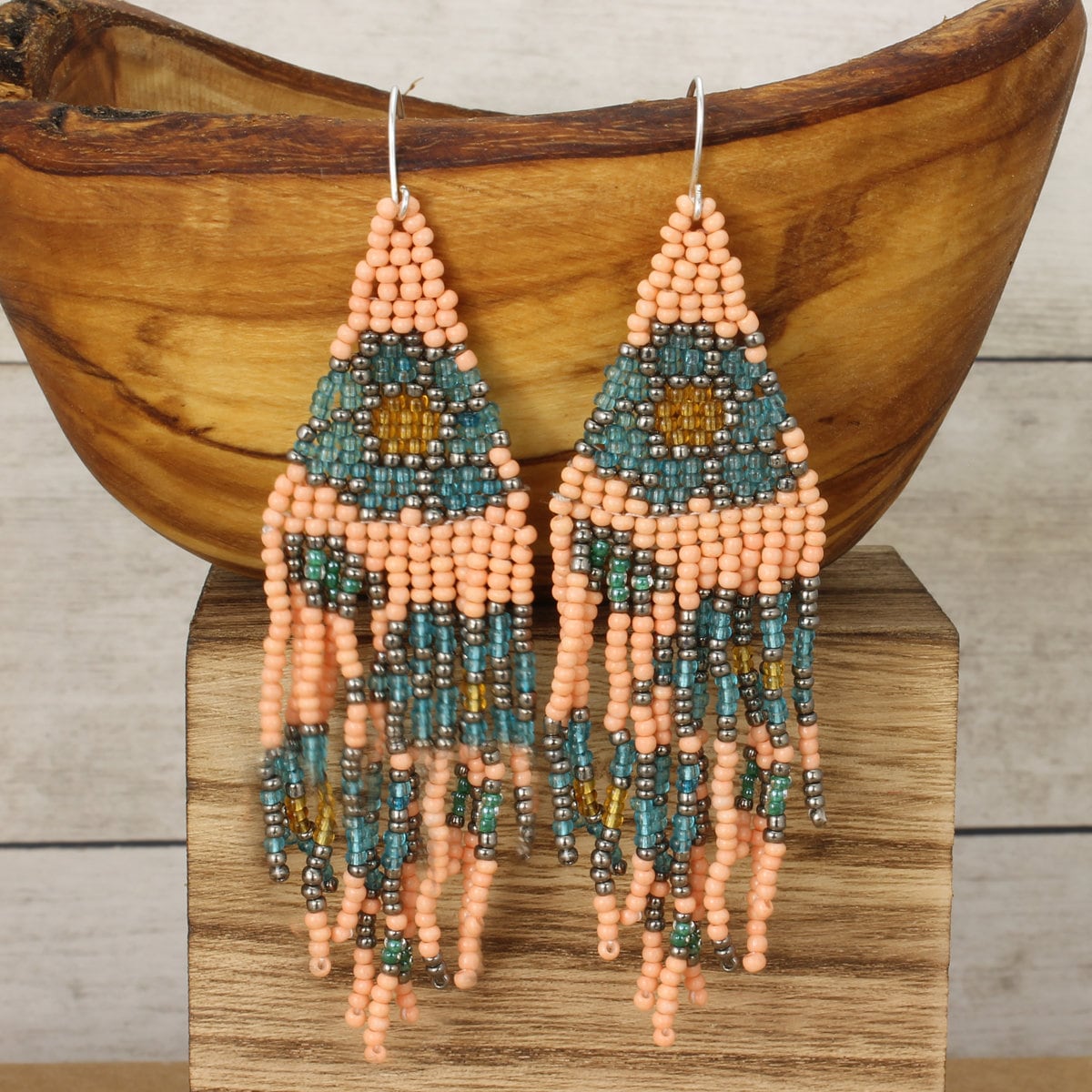Fringe Floral Earrings featuring large pastel glass beads in light blue and peach tones, handmade with boho-inspired floral designs. These statement earrings add a soft, feminine touch with delicate fringe details, perfect for women who love artisanal, colorful jewelry. Ideal gift for birthdays, holidays, or special occasions, combining elegance and playful charm to elevate casual or dressy outfits with handcrafted style.