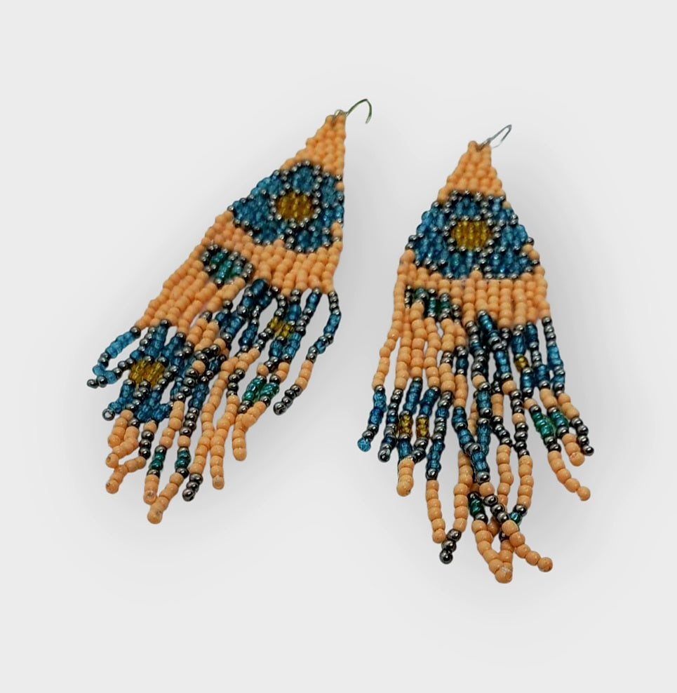 Fringe Floral Earrings featuring large pastel glass beads in light blue and peach tones, handmade with boho-inspired floral designs. These statement earrings add a soft, feminine touch with delicate fringe details, perfect for women who love artisanal, colorful jewelry. Ideal gift for birthdays, holidays, or special occasions, combining elegance and playful charm to elevate casual or dressy outfits with handcrafted style.
