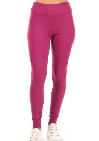 Fuchsia high-waisted leggings for women, designed with full-length seamless construction for maximum comfort and flexibility. Made from stretchy, breathable fabric, these solid color workout yoga pants offer excellent support for fitness and activewear needs. Perfect for yoga, running, or gym sessions, these vibrant leggings combine style and performance, providing a flattering fit that moves with your body during any exercise routine or casual wear.