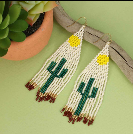 Cactus Earrings featuring Southwest-style glass beadwork with large tassels and fringe design, handmade statement jewelry for women. These colorful earrings showcase intricate bead patterns inspired by desert motifs, perfect for adding bold flair to boho or festival outfits. Lightweight and eye-catching, they make a thoughtful handmade gift for women who love unique, artisanal accessories with southwestern charm and vibrant style.