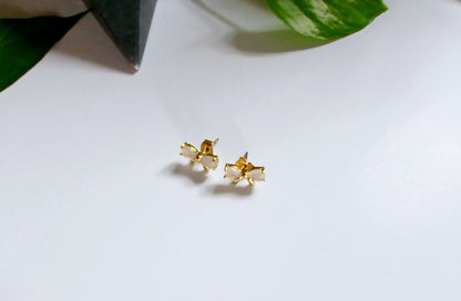 Gold-plated ribbon bow stud earrings featuring a delicate bow design with a polished, elegant finish for a feminine and timeless look. These lightweight stud earrings are perfect for everyday wear or special occasions, adding a subtle touch of charm and sparkle to any outfit. A thoughtful jewelry gift for women, teens, or bridesmaids, ideal for birthdays, holidays, weddings, or stylish minimal accessories lovers.