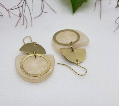 Lightweight gold resin earrings featuring modern geometric dangle design inspired by Art Deco style. These statement earrings for women combine bold shapes with a sleek finish, making them a unique accessory for everyday wear or special occasions. Handmade with attention to detail, they serve as a stylish gift for her who loves contemporary, eye-catching jewelry that blends elegance and modern artistry effortlessly.