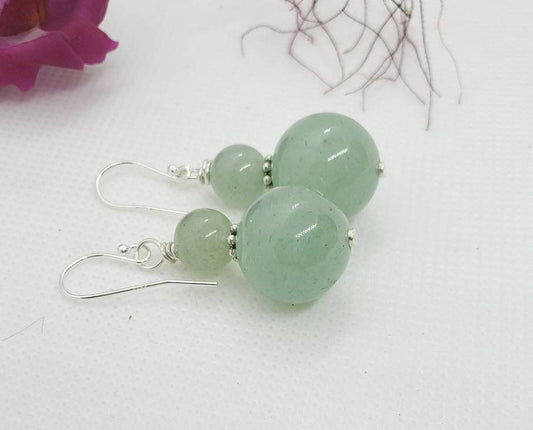 Green Aventurine Jade Earrings featuring 8-12mm natural stones set in sterling silver dangle style, perfect for boho-inspired jewelry lovers. These exotic green earrings add vibrant color and natural elegance to any outfit. Handmade with genuine stones, they offer healing properties and a unique aesthetic. Ideal as a thoughtful gift for her, suitable for casual wear, special occasions, or festival fashion. Stylish, earthy, and timeless.