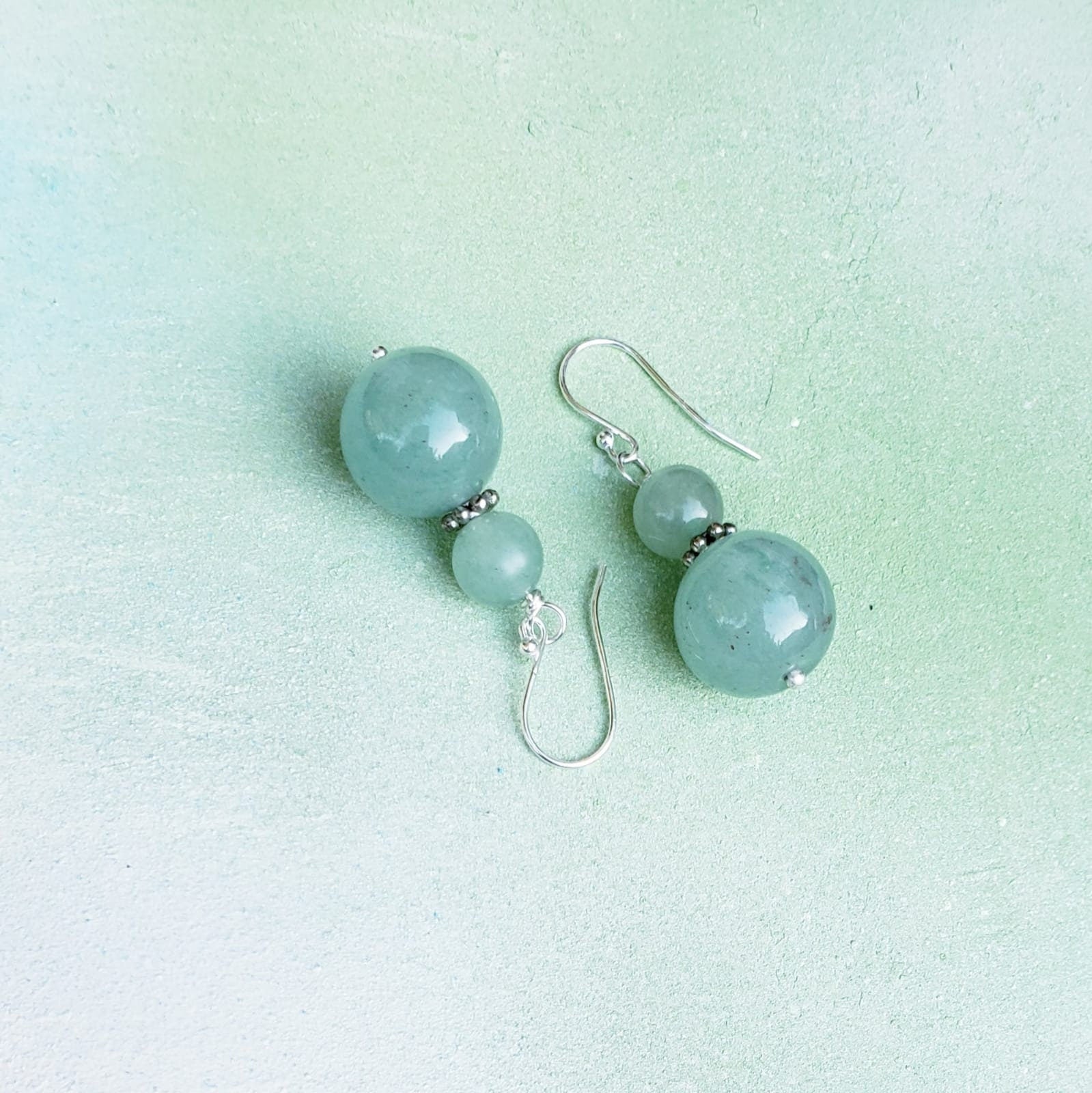 Green Aventurine Jade Earrings featuring 8-12mm natural stones set in sterling silver dangle style, perfect for boho-inspired jewelry lovers. These exotic green earrings add vibrant color and natural elegance to any outfit. Handmade with genuine stones, they offer healing properties and a unique aesthetic. Ideal as a thoughtful gift for her, suitable for casual wear, special occasions, or festival fashion. Stylish, earthy, and timeless.