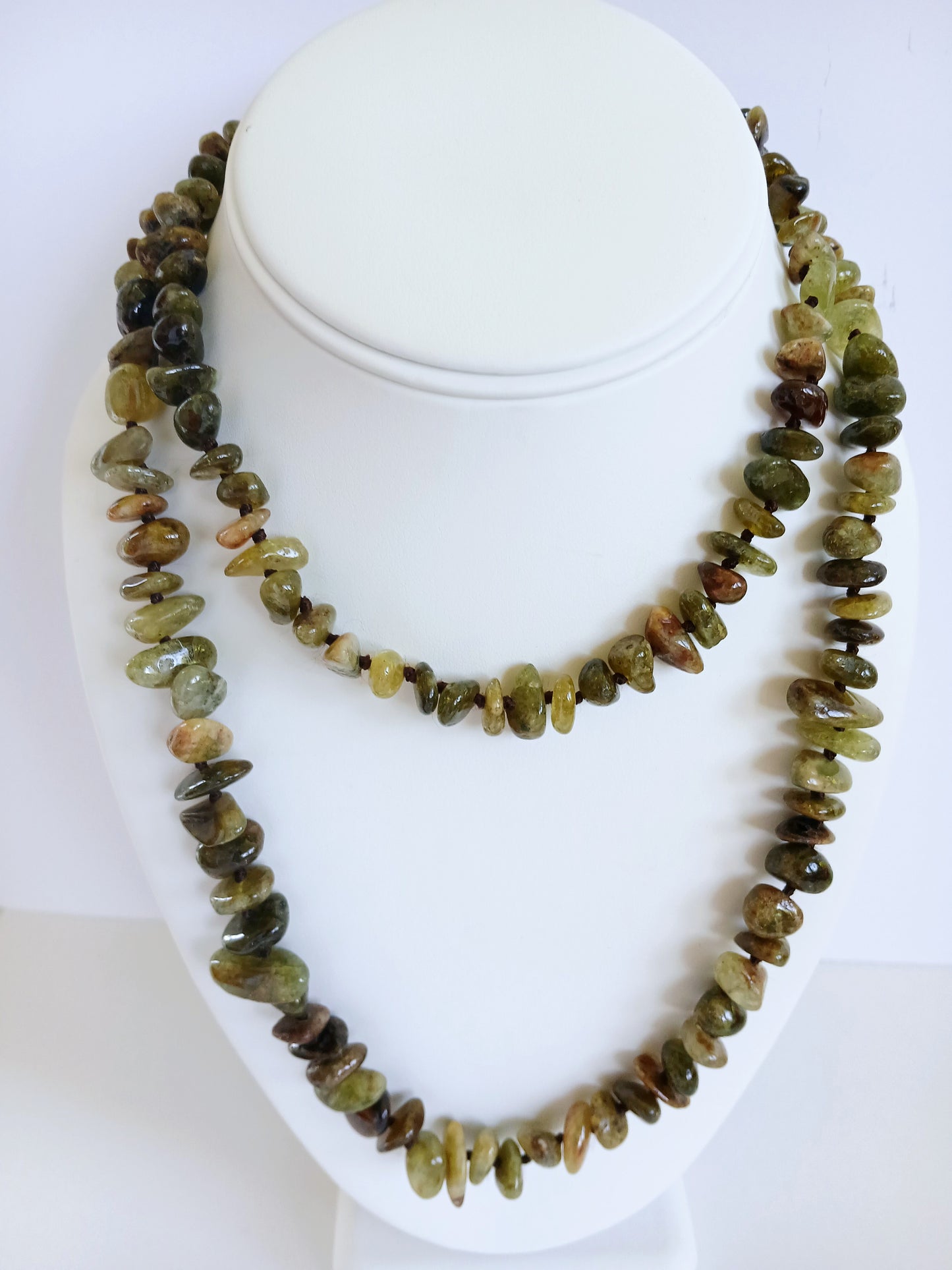 Natural Green Garnet Long Necklace for Women featuring double strands of vibrant green garnet gemstones, expertly handcrafted for elegance and durability. This stunning gemstone jewelry piece is secured with a sterling silver clasp, symbolizing abundance and prosperity. Perfect for adding a touch of natural beauty and positive energy to any outfit, making it an ideal gift for her on birthdays, anniversaries, or special occasions.