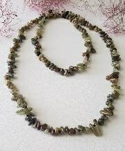 Natural Green Garnet Long Necklace for Women featuring double strands of vibrant green garnet gemstones, expertly handcrafted for elegance and durability. This stunning gemstone jewelry piece is secured with a sterling silver clasp, symbolizing abundance and prosperity. Perfect for adding a touch of natural beauty and positive energy to any outfit, making it an ideal gift for her on birthdays, anniversaries, or special occasions.
