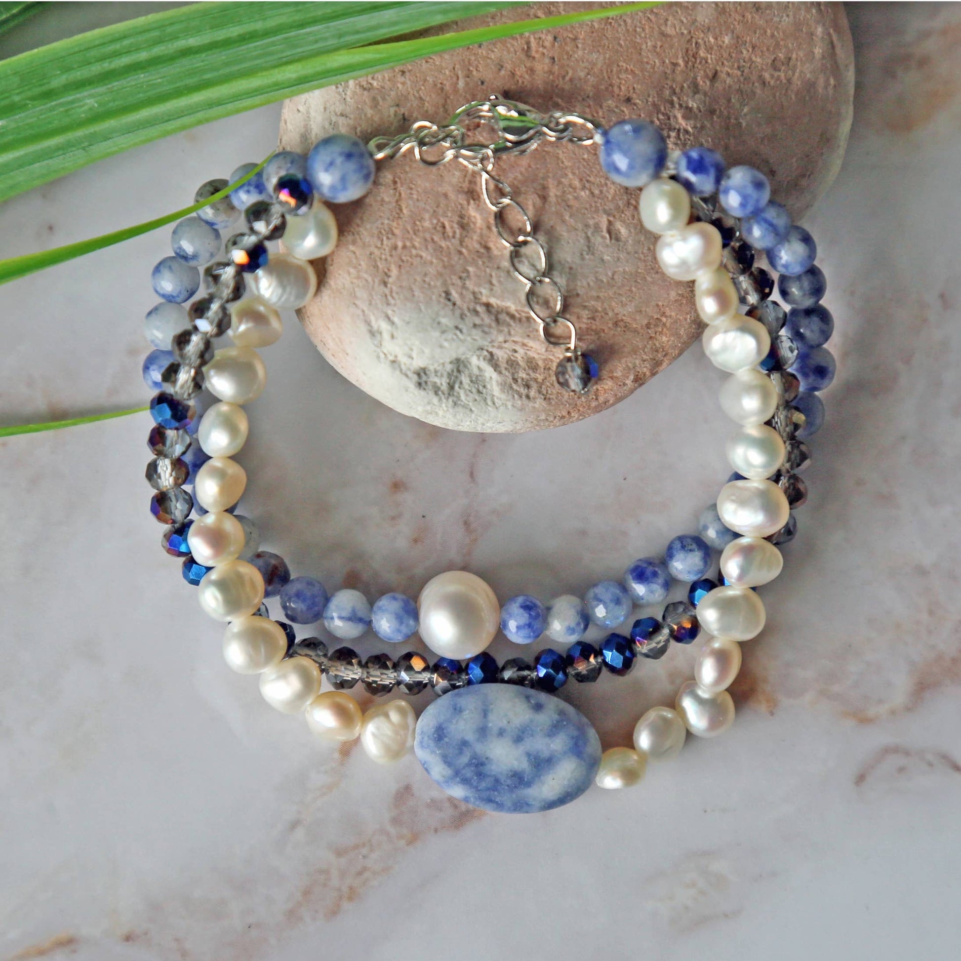 Handmade multi-strand bracelet featuring sodalite and cultured pearl beads, designed as chunky crystal jewelry with a minimalist pendant accent. This beaded bracelet offers a stylish and elegant accessory perfect for girls who love unique, handcrafted pieces. Combining natural gemstones with delicate craftsmanship, it makes a thoughtful gift ideal for special occasions or everyday wear, blending boho charm with modern minimalist style.
