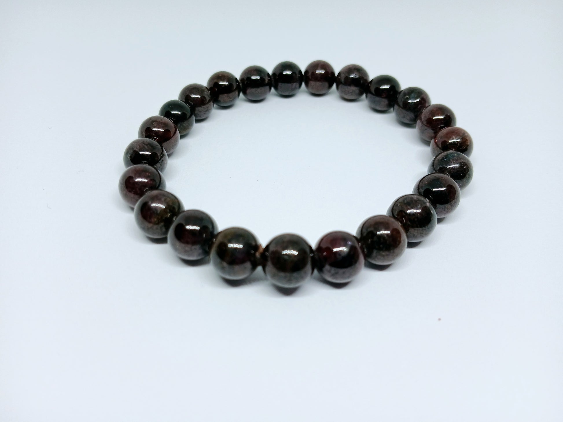 Garnet Handmade Bracelet featuring natural deep red crystal beads crafted into a healing energy design for women and men. This unisex gemstone bracelet promotes strength, passion, and energy balance, making it a meaningful gift for her or him. Perfect for daily wear, meditation, or spiritual wellness, it blends natural beauty with artisan craftsmanship. Lightweight and powerful, this bracelet adds a bold touch to any outfit while supporting emotional and physical grounding.