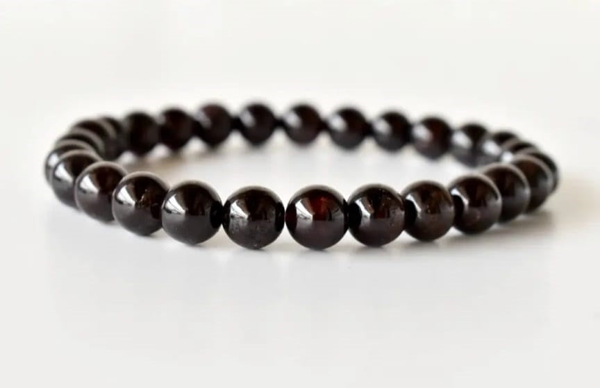Garnet Handmade Bracelet featuring natural deep red crystal beads crafted into a healing energy design for women and men. This unisex gemstone bracelet promotes strength, passion, and energy balance, making it a meaningful gift for her or him. Perfect for daily wear, meditation, or spiritual wellness, it blends natural beauty with artisan craftsmanship. Lightweight and powerful, this bracelet adds a bold touch to any outfit while supporting emotional and physical grounding.