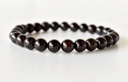 Garnet Handmade Bracelet featuring natural deep red crystal beads crafted into a healing energy design for women and men. This unisex gemstone bracelet promotes strength, passion, and energy balance, making it a meaningful gift for her or him. Perfect for daily wear, meditation, or spiritual wellness, it blends natural beauty with artisan craftsmanship. Lightweight and powerful, this bracelet adds a bold touch to any outfit while supporting emotional and physical grounding.