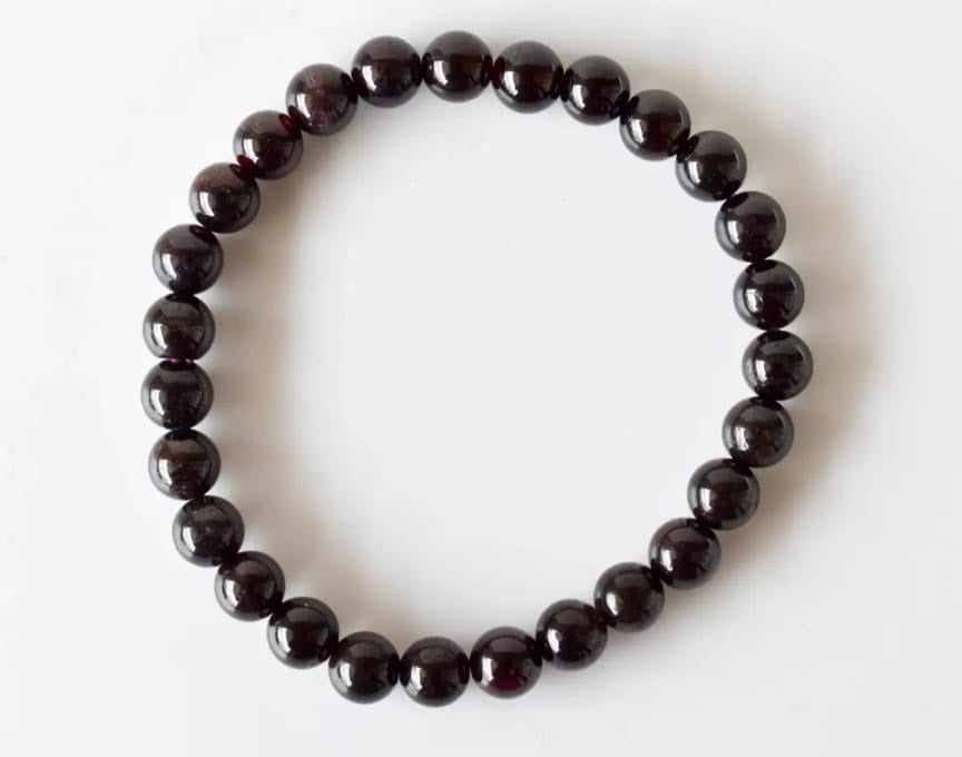 Garnet Handmade Bracelet featuring natural deep red crystal beads crafted into a healing energy design for women and men. This unisex gemstone bracelet promotes strength, passion, and energy balance, making it a meaningful gift for her or him. Perfect for daily wear, meditation, or spiritual wellness, it blends natural beauty with artisan craftsmanship. Lightweight and powerful, this bracelet adds a bold touch to any outfit while supporting emotional and physical grounding.