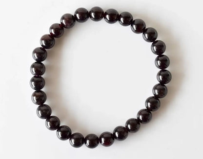 Garnet Handmade Bracelet featuring natural deep red crystal beads crafted into a healing energy design for women and men. This unisex gemstone bracelet promotes strength, passion, and energy balance, making it a meaningful gift for her or him. Perfect for daily wear, meditation, or spiritual wellness, it blends natural beauty with artisan craftsmanship. Lightweight and powerful, this bracelet adds a bold touch to any outfit while supporting emotional and physical grounding.