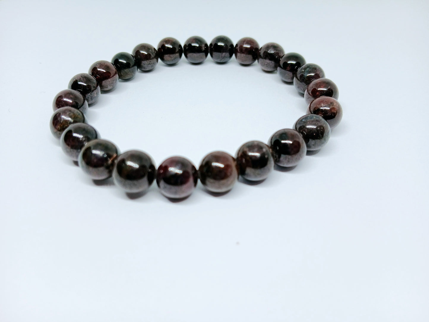 Garnet Handmade Bracelet featuring natural deep red crystal beads crafted into a healing energy design for women and men. This unisex gemstone bracelet promotes strength, passion, and energy balance, making it a meaningful gift for her or him. Perfect for daily wear, meditation, or spiritual wellness, it blends natural beauty with artisan craftsmanship. Lightweight and powerful, this bracelet adds a bold touch to any outfit while supporting emotional and physical grounding.