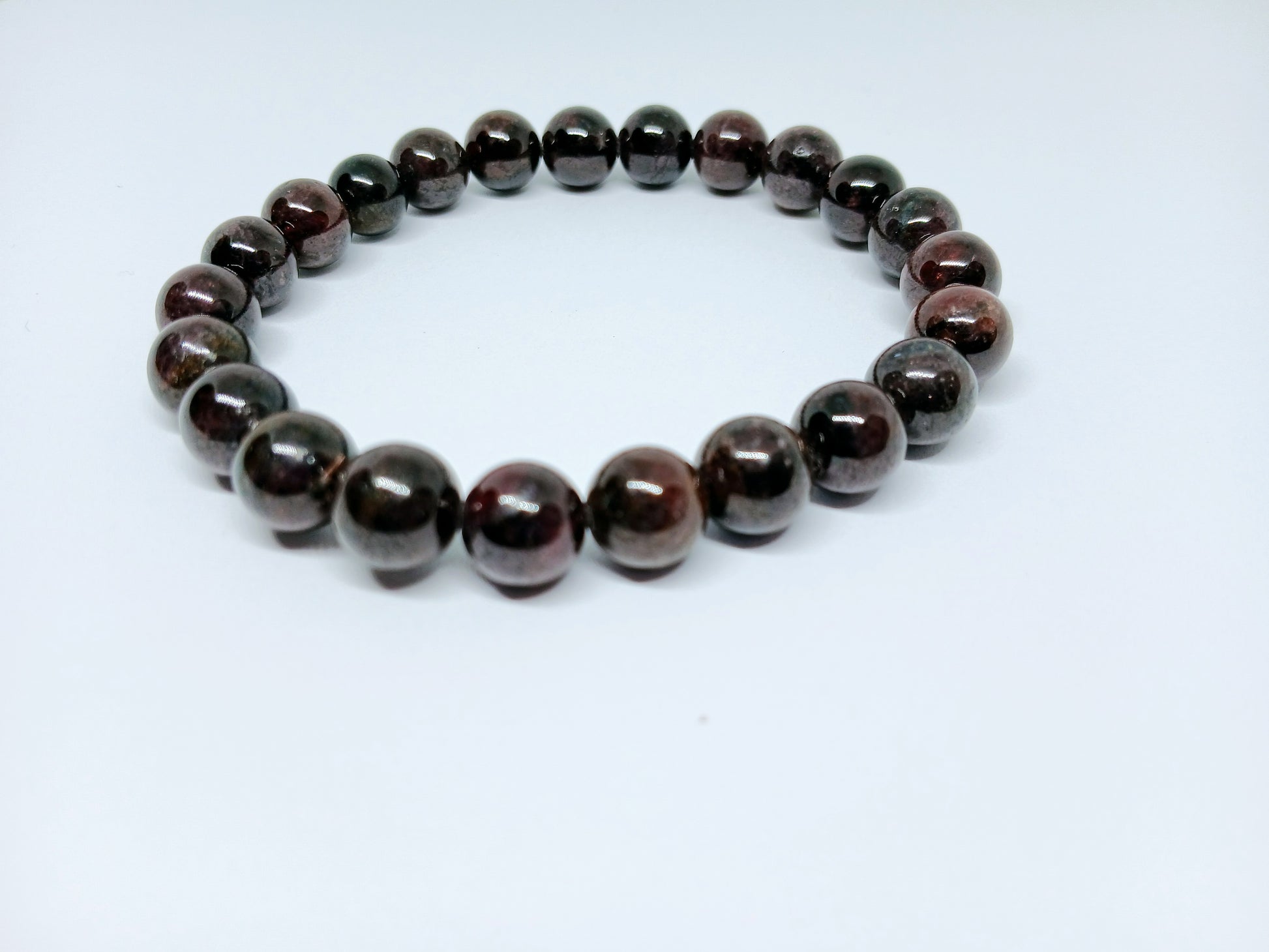 Garnet Handmade Bracelet featuring natural deep red crystal beads crafted into a healing energy design for women and men. This unisex gemstone bracelet promotes strength, passion, and energy balance, making it a meaningful gift for her or him. Perfect for daily wear, meditation, or spiritual wellness, it blends natural beauty with artisan craftsmanship. Lightweight and powerful, this bracelet adds a bold touch to any outfit while supporting emotional and physical grounding.
