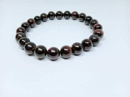Garnet Handmade Bracelet featuring natural deep red crystal beads crafted into a healing energy design for women and men. This unisex gemstone bracelet promotes strength, passion, and energy balance, making it a meaningful gift for her or him. Perfect for daily wear, meditation, or spiritual wellness, it blends natural beauty with artisan craftsmanship. Lightweight and powerful, this bracelet adds a bold touch to any outfit while supporting emotional and physical grounding.