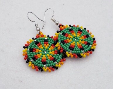 Green Handmade Beaded Earrings for women featuring intricate native-style beadwork in a bold boho design. These statement green medallion earrings showcase vibrant beads arranged in festival-inspired patterns, perfect for adding color and artistry to any outfit. Ideal gift for women who love unique, handcrafted jewelry with cultural flair. Lightweight and eye-catching, these earrings complement casual and dressy looks alike, making them perfect for festivals or everyday wear.