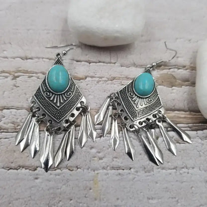 Handmade turquoise tassel earrings featuring natural stone beads and diamond alloy accents, perfect for women who love boho jewelry. These lightweight statement earrings combine vibrant turquoise hues with elegant tassel details for a unique and stylish look. Ideal for casual or dressy occasions, they add a pop of color and texture to any outfit. A beautiful accessory that blends natural elements with chic design, making it a perfect gift or everyday favorite.