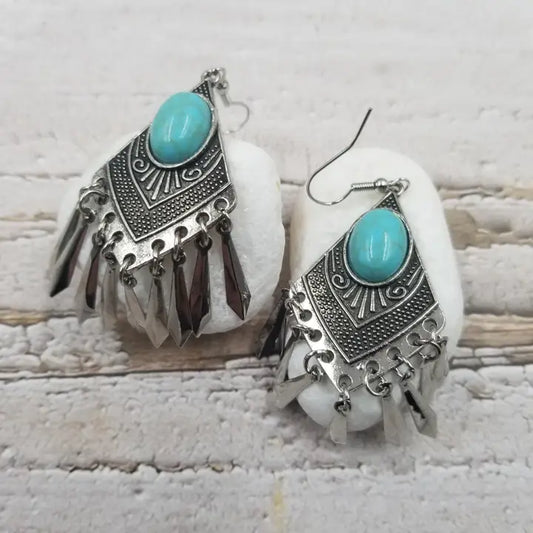 Handmade turquoise tassel earrings featuring natural stone beads and diamond alloy accents, perfect for women who love boho jewelry. These lightweight statement earrings combine vibrant turquoise hues with elegant tassel details for a unique and stylish look. Ideal for casual or dressy occasions, they add a pop of color and texture to any outfit. A beautiful accessory that blends natural elements with chic design, making it a perfect gift or everyday favorite.
