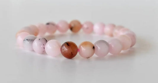 Pink Opal Bracelet featuring natural stone beads handcrafted into a soft pink crystal gemstone design, perfect for women who love healing and elegant jewelry. This delicate bracelet promotes emotional healing, love, and calm energy, making it an ideal gift for her or a thoughtful bridesmaid bracelet. Lightweight and feminine, it blends artisanal craftsmanship with the gentle beauty of pink opal, suitable for everyday wear or meaningful special occasions.
