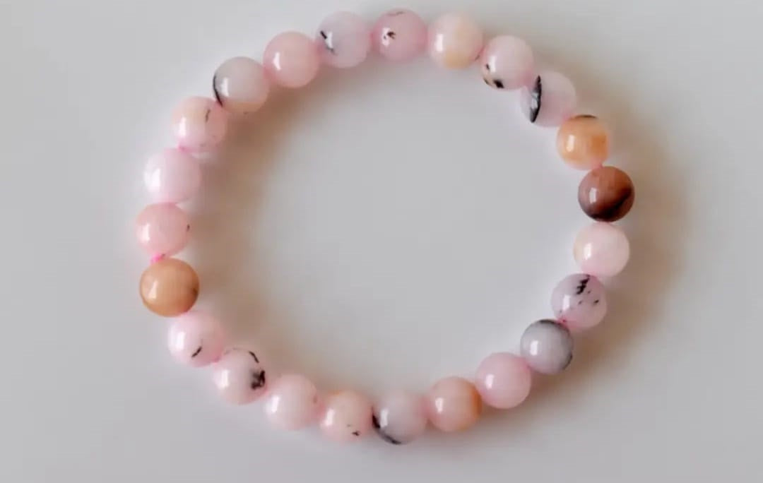 Pink Opal Bracelet featuring natural stone beads handcrafted into a soft pink crystal gemstone design, perfect for women who love healing and elegant jewelry. This delicate bracelet promotes emotional healing, love, and calm energy, making it an ideal gift for her or a thoughtful bridesmaid bracelet. Lightweight and feminine, it blends artisanal craftsmanship with the gentle beauty of pink opal, suitable for everyday wear or meaningful special occasions.