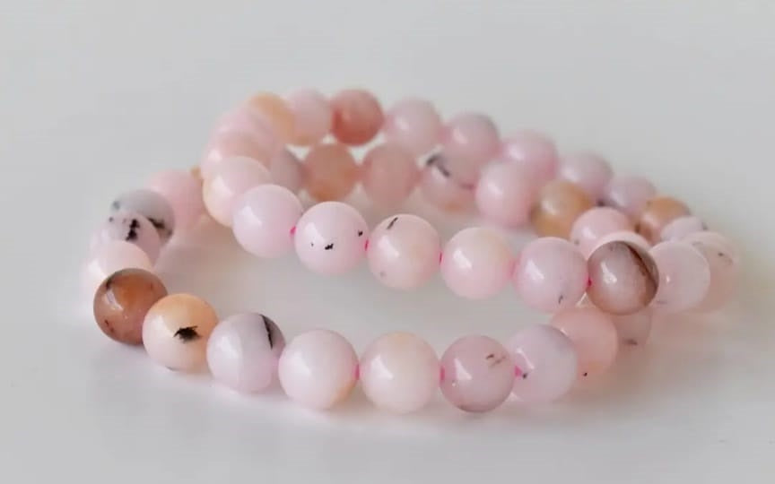 Pink Opal Bracelet featuring natural stone beads handcrafted into a soft pink crystal gemstone design, perfect for women who love healing and elegant jewelry. This delicate bracelet promotes emotional healing, love, and calm energy, making it an ideal gift for her or a thoughtful bridesmaid bracelet. Lightweight and feminine, it blends artisanal craftsmanship with the gentle beauty of pink opal, suitable for everyday wear or meaningful special occasions.