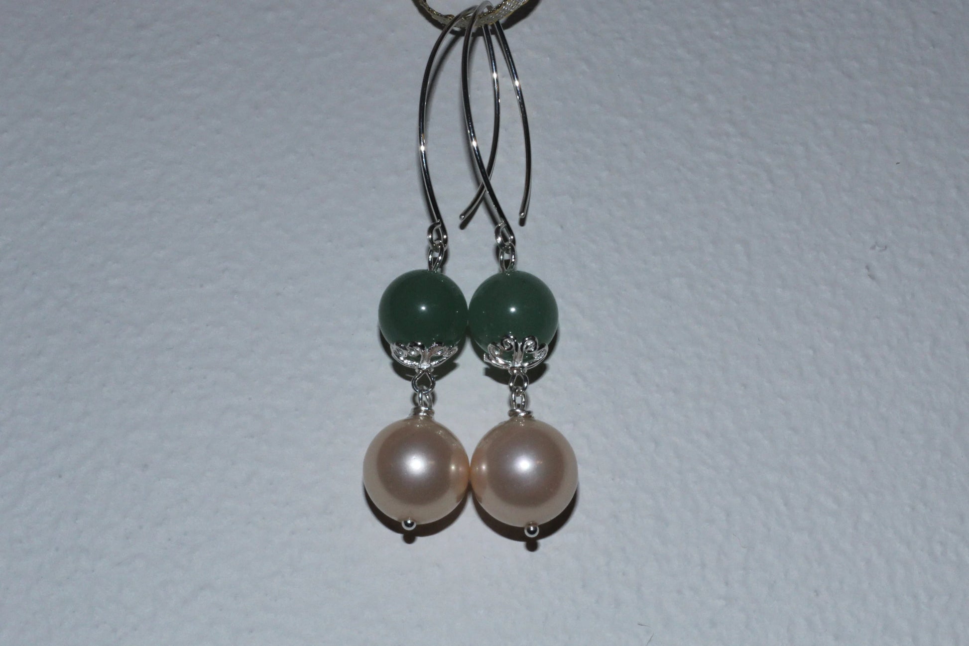 Green Aventurine Earrings with Freshwater Pearl Dangles handcrafted in sterling silver for an elegant, timeless look. These earrings feature natural green aventurine stones paired with lustrous freshwater pearls, symbolizing luck, prosperity, and calm energy. Perfect for adding a touch of sophistication to any outfit, they make a thoughtful gift for women who appreciate handmade gemstone jewelry, natural healing crystals, and classic accessories that blend beauty with spiritual balance.