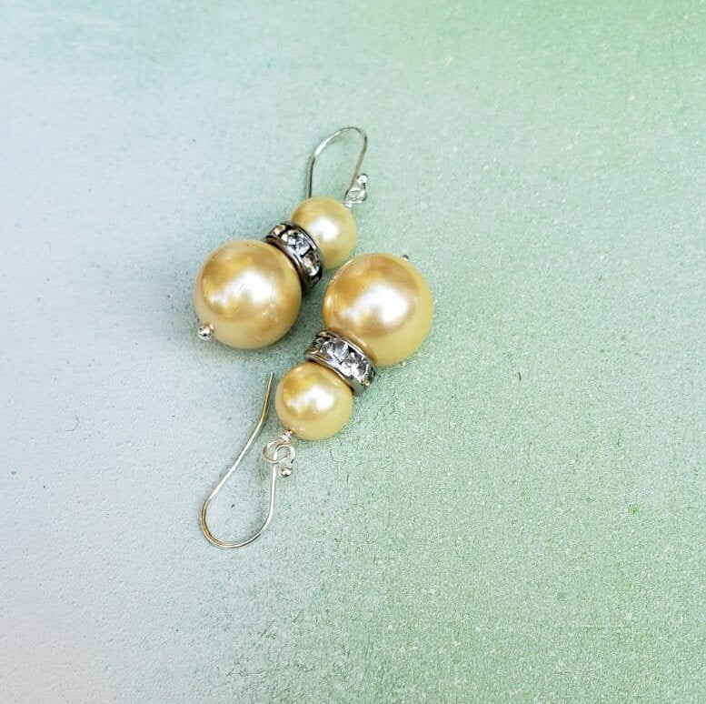 Natural Shell Pearl Dangle Earrings featuring ivory pearls sized 6-10mm set in sterling silver, handcrafted for women. These elegant bridesmaid earrings combine classic pearl beauty with delicate shell accents, creating a timeless accessory perfect for weddings, special occasions, or everyday wear. Lightweight and refined, they make a thoughtful gift for her, blending artisanal craftsmanship with sophisticated style for unforgettable jewelry moments.
