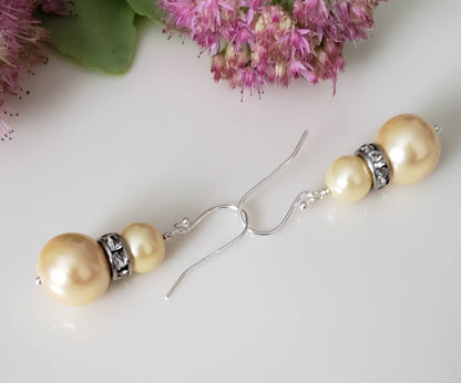 Natural Shell Pearl Dangle Earrings featuring ivory pearls sized 6-10mm set in sterling silver, handcrafted for women. These elegant bridesmaid earrings combine classic pearl beauty with delicate shell accents, creating a timeless accessory perfect for weddings, special occasions, or everyday wear. Lightweight and refined, they make a thoughtful gift for her, blending artisanal craftsmanship with sophisticated style for unforgettable jewelry moments.