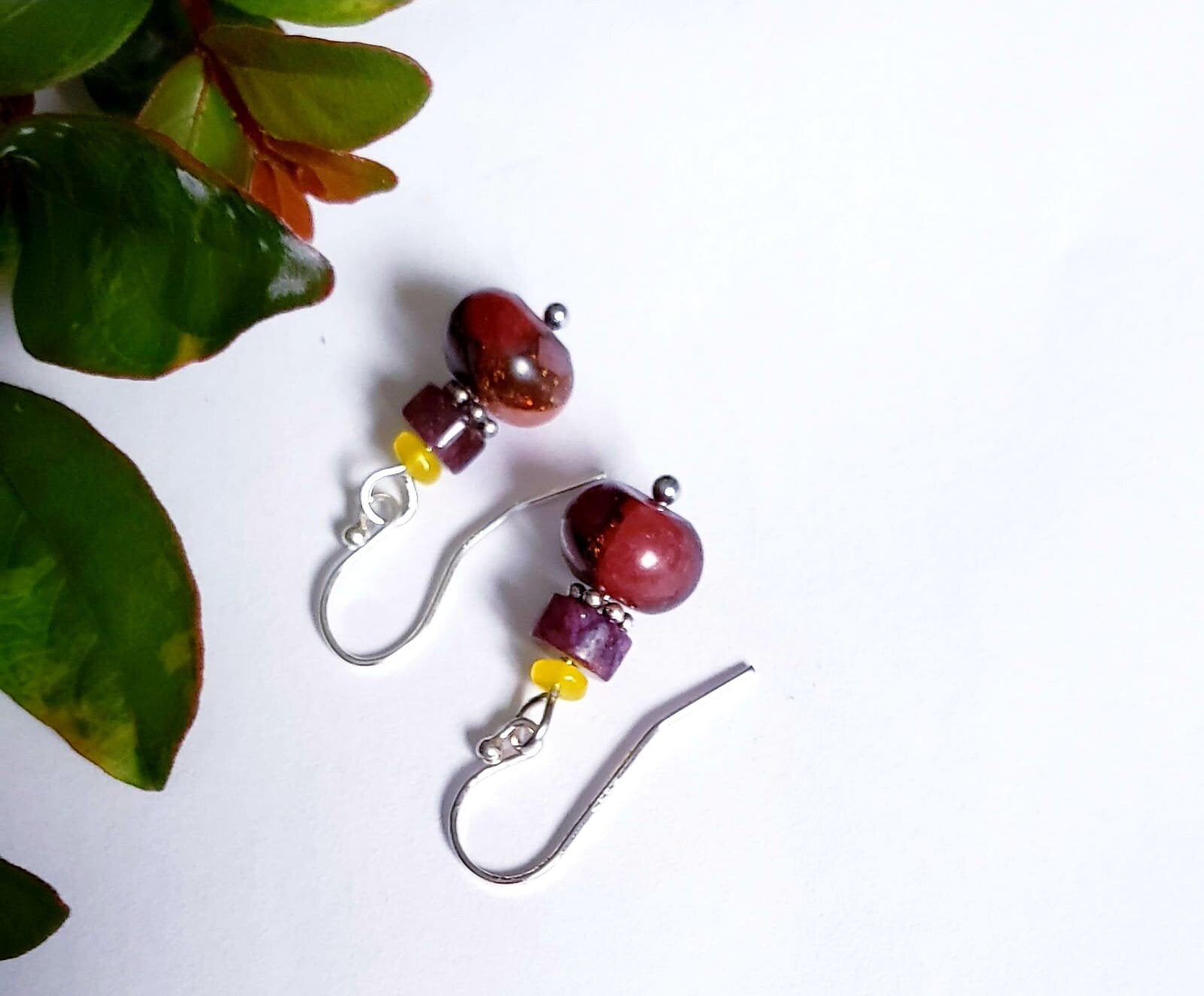 Jade Earrings featuring sterling silver settings with brown and pink jade stones, handcrafted for women. These elegant earrings are perfect for bridesmaids, bridal parties, or as a stylish fashion gift for her. The unique combination of earthy tones and delicate craftsmanship creates a timeless accessory ideal for weddings, special occasions, or everyday wear. Lightweight and graceful, these handmade earrings blend sophistication with natural beauty.