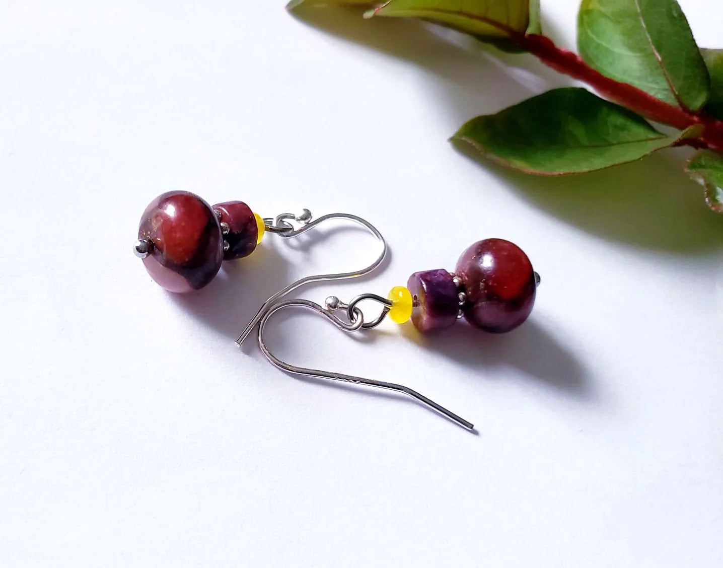 Jade Earrings featuring sterling silver settings with brown and pink jade stones, handcrafted for women. These elegant earrings are perfect for bridesmaids, bridal parties, or as a stylish fashion gift for her. The unique combination of earthy tones and delicate craftsmanship creates a timeless accessory ideal for weddings, special occasions, or everyday wear. Lightweight and graceful, these handmade earrings blend sophistication with natural beauty.