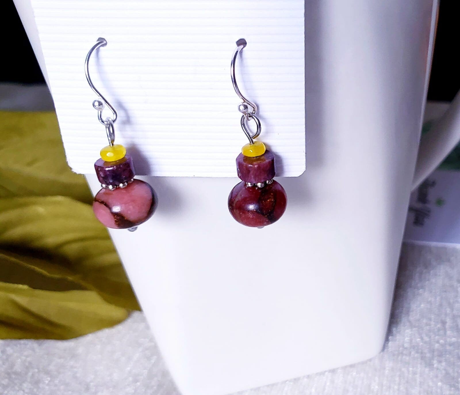 Jade Earrings featuring sterling silver settings with brown and pink jade stones, handcrafted for women. These elegant earrings are perfect for bridesmaids, bridal parties, or as a stylish fashion gift for her. The unique combination of earthy tones and delicate craftsmanship creates a timeless accessory ideal for weddings, special occasions, or everyday wear. Lightweight and graceful, these handmade earrings blend sophistication with natural beauty.