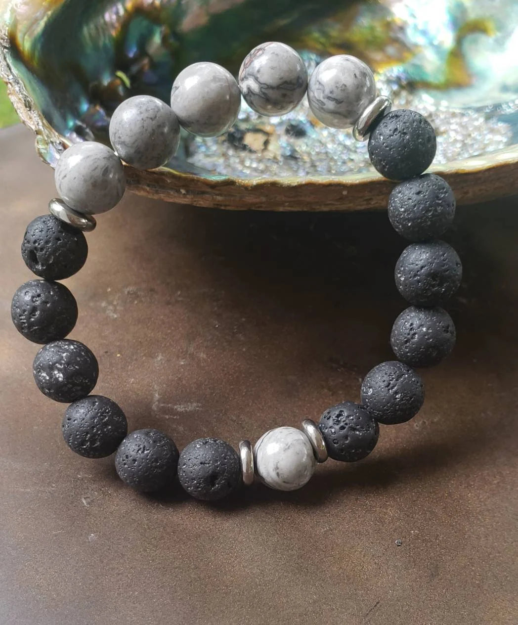 Jasper Lava Stone Diffuser Bracelet handcrafted for men, featuring natural jasper and porous lava stones perfect for essential oil diffusion. This chakra-inspired jewelry piece promotes balance, grounding, and positive energy while allowing personalized aromatherapy on the go. Adjustable and durable, it’s ideal for everyday wear, meditation, or mindfulness practices. A thoughtful gift for men who appreciate handmade jewelry, wellness accessories, and stylish, meaningful gemstone bracelets.