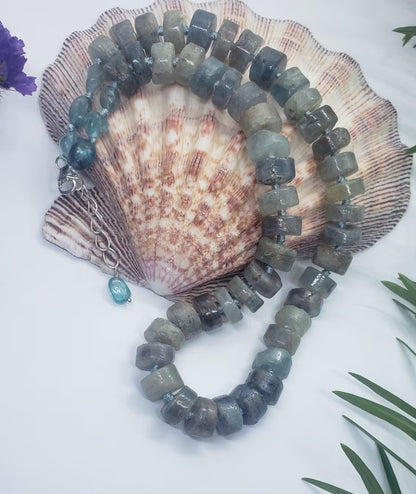 Green Emerald Gemstone Necklace featuring vibrant emerald and deep blue kyanite beads, handcrafted into a boho-inspired design with sterling silver accents. This elegant handmade necklace is perfect for women who appreciate unique, natural gemstone jewelry. Ideal gift for moms or special occasions, blending timeless style with spiritual energy. A stunning piece that complements both casual and formal looks, highlighting artisanal craftsmanship and meaningful stones.