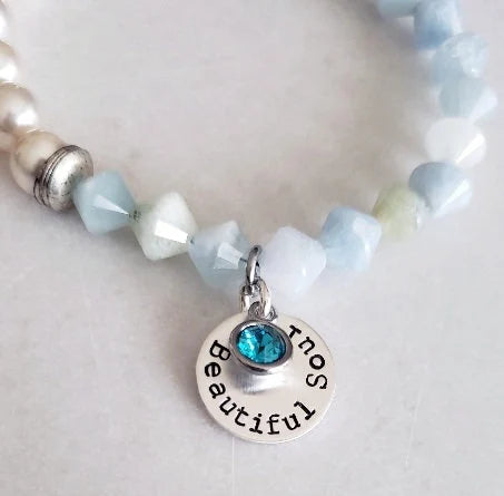 Aquamarine Pearl Bracelet featuring handmade beaded design combining soothing aquamarine stones with lustrous pearls. This inspirational jewelry piece is perfect as a March birthstone gift, symbolizing calmness, courage, and good luck. Ideal for her or as a thoughtful mother’s gift, it blends elegant style with meaningful healing properties. Lightweight and versatile, this bracelet adds a delicate, spiritual touch to everyday wear or special occasions, celebrating love and positive energy.