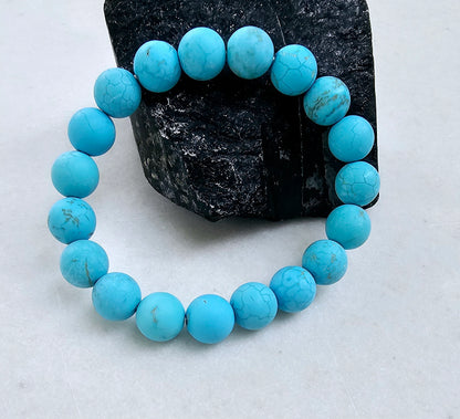 Magnesite Turquoise Stretch Bracelet designed for women and men, featuring blue stone beads known for their healing and chakra-balancing properties. This handcrafted boho crystal jewelry offers both style and spiritual energy, perfect for those seeking natural wellness accessories. Lightweight and comfortable, it makes a thoughtful gift that promotes calmness, positivity, and balance. Ideal for everyday wear, meditation, or adding a vibrant, earthy touch to any outfit.
