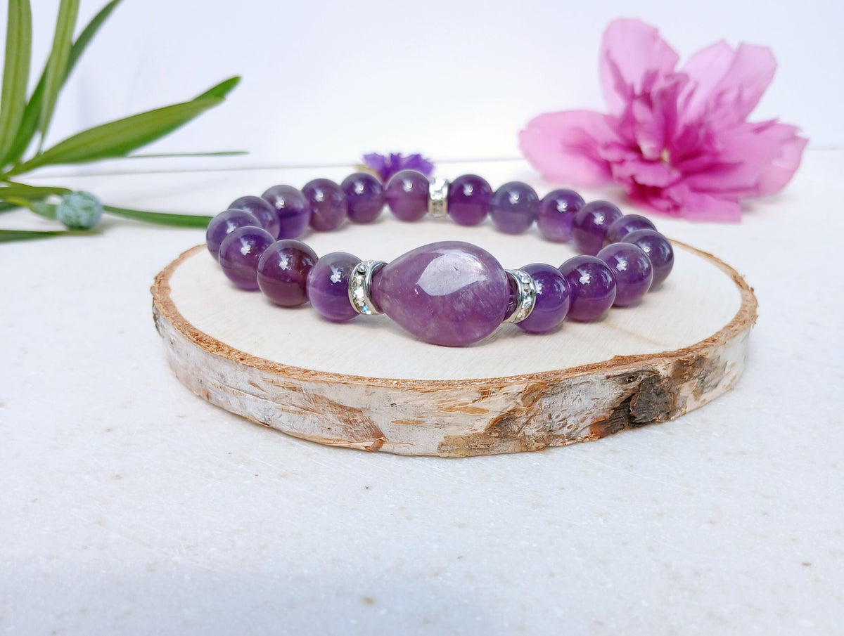 Amethyst Healing Bracelet handcrafted with natural amethyst and moonstone crystals, known for promoting happiness, healing, and spiritual balance. This elegant handmade bracelet combines calming purple tones with iridescent moonstone for a serene, empowering look. Ideal gift for her, this crystal jewelry piece supports emotional wellness and attracts positive energy. Perfect for birthdays, wellness gifts, or everyday wear with mindful intention.