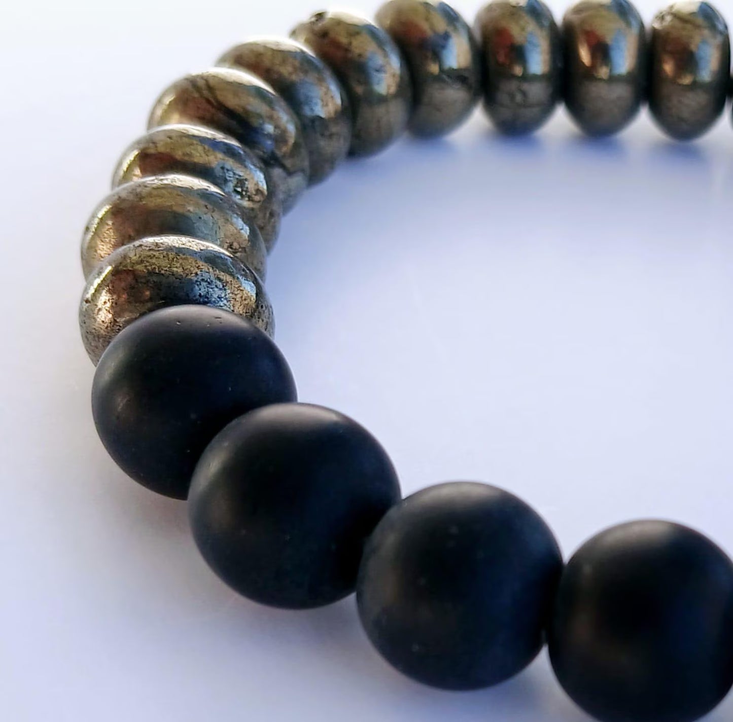 Black Onyx and Pyrite Bracelet featuring handmade beaded natural stones crafted into a crystal healing jewelry piece for men and women. This spiritual bracelet combines the grounding energy of black onyx with the protective power of pyrite, promoting balance and positive energy. Lightweight and stylish, it makes a meaningful gift for him or her. Perfect for everyday wear, meditation, or as a unique accessory blending artisanal craftsmanship with natural healing properties.