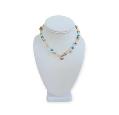 Beige Seashell and Turquoise Choker handcrafted with natural shells and vibrant turquoise beads for a beach-inspired, boho-chic look. This handmade necklace adds a coastal, summery touch to any outfit, perfect for casual wear, vacations, or seaside adventures. Ideal as a thoughtful gift for women who love beach jewelry, handmade accessories, or unique statement pieces that combine natural materials, artisanal craftsmanship, and effortless coastal style.