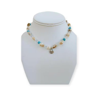 Beige Seashell and Turquoise Choker handcrafted with natural shells and vibrant turquoise beads for a beach-inspired, boho-chic look. This handmade necklace adds a coastal, summery touch to any outfit, perfect for casual wear, vacations, or seaside adventures. Ideal as a thoughtful gift for women who love beach jewelry, handmade accessories, or unique statement pieces that combine natural materials, artisanal craftsmanship, and effortless coastal style.