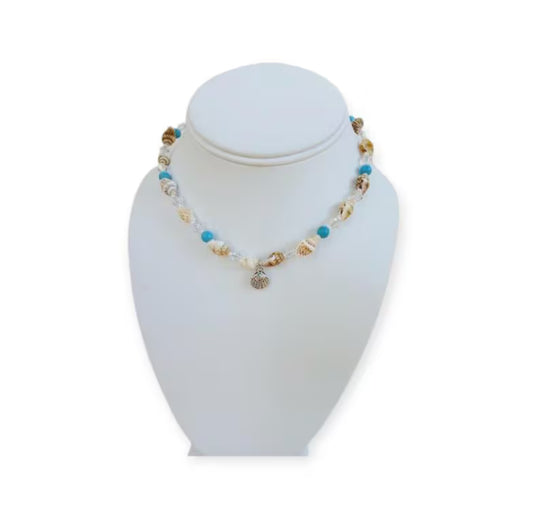 Beige Seashell and Turquoise Choker handcrafted with natural shells and vibrant turquoise beads for a beach-inspired, boho-chic look. This handmade necklace adds a coastal, summery touch to any outfit, perfect for casual wear, vacations, or seaside adventures. Ideal as a thoughtful gift for women who love beach jewelry, handmade accessories, or unique statement pieces that combine natural materials, artisanal craftsmanship, and effortless coastal style.